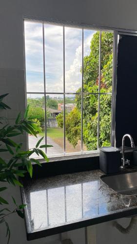 a kitchen window with a view of a yard at Compact Studios Close to Shopping Centers, Downtown, Arena, Airport in Manaus
