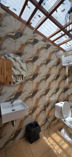 a bathroom with a sink and a toilet at Teras Danu in Bedugul