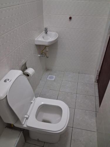 a bathroom with a toilet and a sink at Machakos Town Studios in Machakos