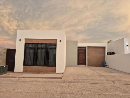 a building with two garage doors and a cloudy sky at casa estefania in San Carlos