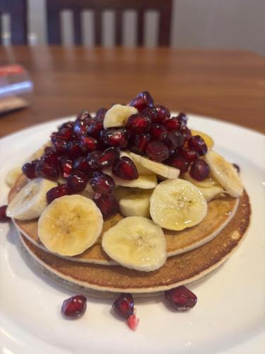 a dessert with bananas and cherries on a plate at Mums Homestay & Studio Apartment-A Real Homestay Experience in Kathmandu