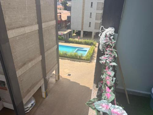 a view of a swimming pool from a balcony at Bliss Homes in Nairobi