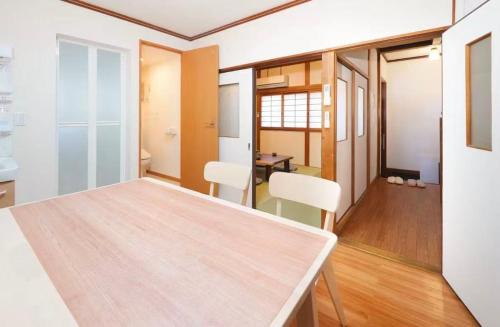 a dining room with a table and chairs at Private Tatami House 4min from Teradacho Sta in Osaka