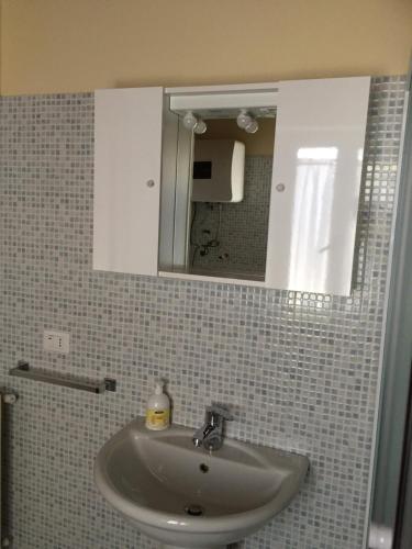- Baño con lavabo, espejo y espejo en casetta dell'Alpino, en LʼAquila