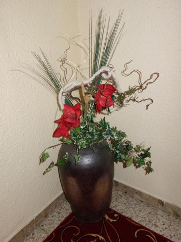 a vase with flowers in it sitting on a table at Gasthof zur Post in Schörfling