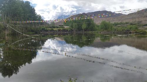 a body of water with prayer flags and a lake at Hotel Grand Shambala in Muktināth