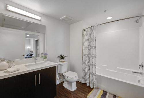 a bathroom with a toilet and a sink and a shower at Luxe on Hollywood Blvd 2BR with FREE PARKING in Los Angeles