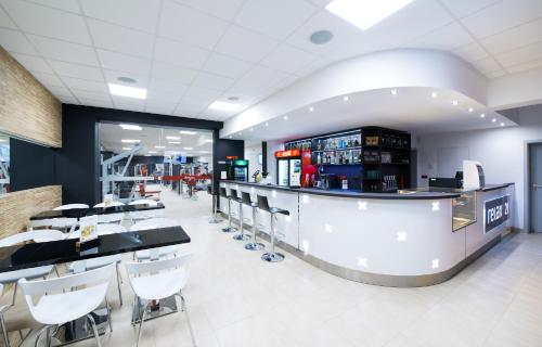a bar in a restaurant with chairs and a counter at Relax21 in Uherský Ostroh