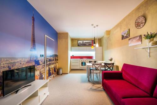 a living room with a red couch and a dining room at Relax21 in Uherský Ostroh