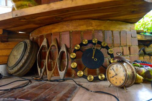 a room with a clock and a bunch of wine barrels at Topuzovi Guest House in Dobrinishte