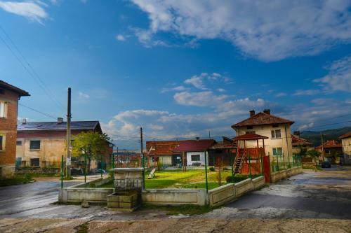 an empty street in a small town with a playground at Topuzovi Guest House in Dobrinishte