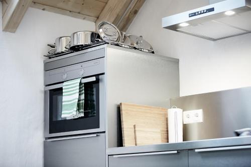 a kitchen with a stove with two pans on top of it at Basalt-Loft in Kottenheim