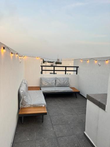 a room with two beds and lights on a roof at La Casa de Coco in Oacalco