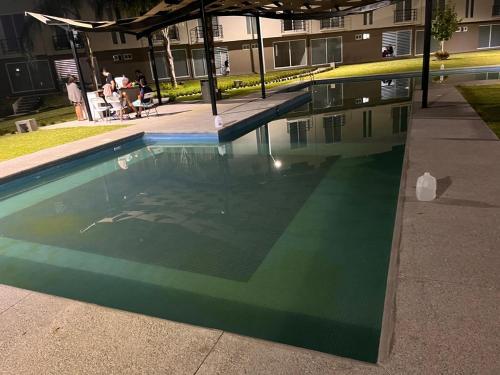 an empty swimming pool in a building with people sitting at La Casa de Coco in Oacalco