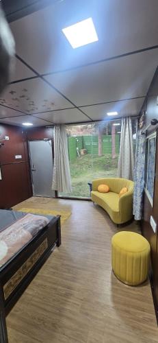 a room with a bed and a couch in a room at Nishatana Farm Stay in Bangalore