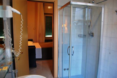 a bathroom with a shower with a glass door at Hotel Brasile in Montecatini Terme