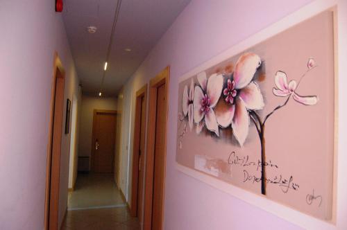 a painting of pink flowers on a wall in a hallway at Hotel Brasile in Montecatini Terme