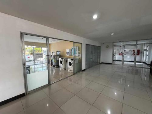 a large empty room with washing machines and windows at Chiang Mai view place in Ban Hua Phrong