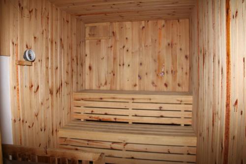a wooden sauna with a bench in a room at Pension Martinské údolí - dependance in Kořenov