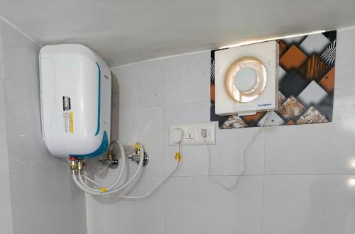 a bathroom with a white toilet and a sink at Glory Farm in Vadāli