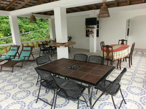 a dining room with a table and chairs at Polish Princess Guest House in Port Antonio