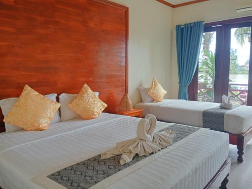 En eller flere senge i et værelse på Paradise Resort