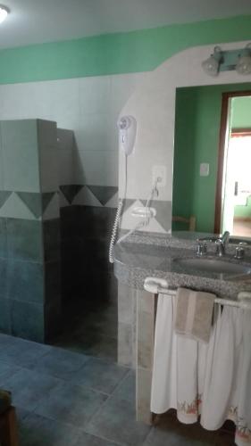 a bathroom with a sink and a mirror at Establecimiento Rural El Chañar in San Rafael