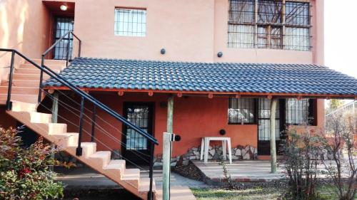 a house with a staircase leading up to it at Establecimiento Rural El Chañar in San Rafael