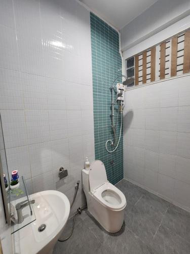 a bathroom with a toilet and a sink at 198 House in Ban Khlong Pleo