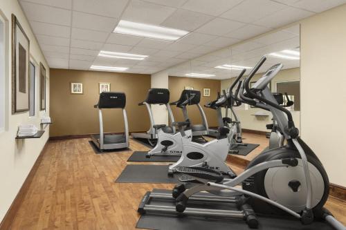 a gym with treadmills and elliptical machines at Country Inn & Suites by Radisson, Macon North, GA in Macon
