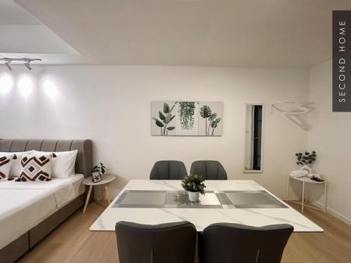 a living room with a bed and a table and chairs at Second Home - Kota Kemuning in Shah Alam