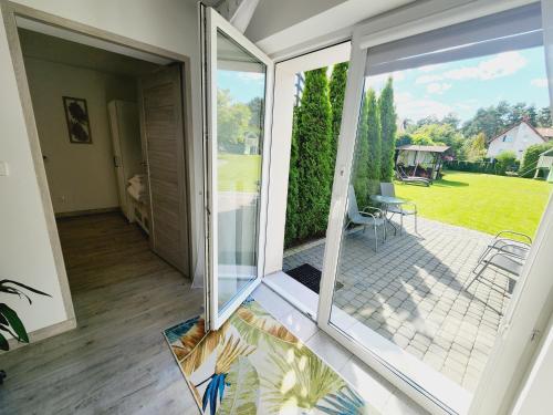 an internal view of a house with sliding glass doors at Dla Przyjaciół - Apartamenty nad morzem in Mosty