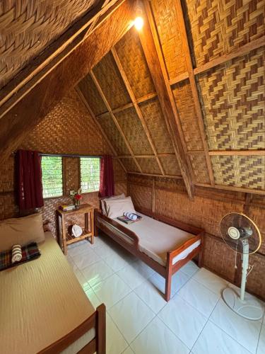 an attic room with a bed and a fan at 6227 Guesthouse in San Juan