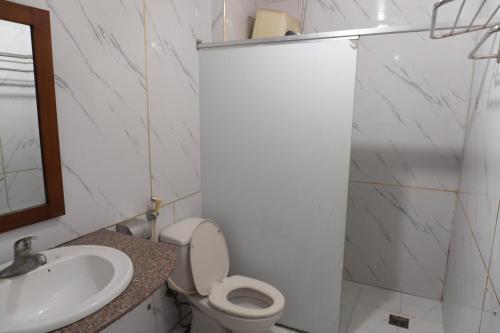 a bathroom with a toilet and a sink at Pho Nang Motel in Hanoi