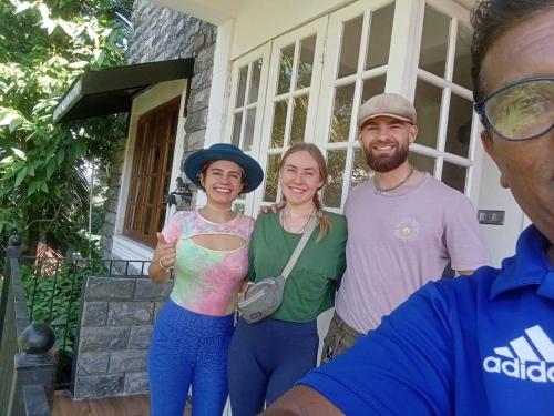 a group of people standing in front of a house at Teirack Rosis Wish in Kandy