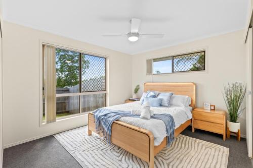 a bedroom with a bed and a window at Family-Friendly 3 Bedroom Home in Hervey Bay in Pialba