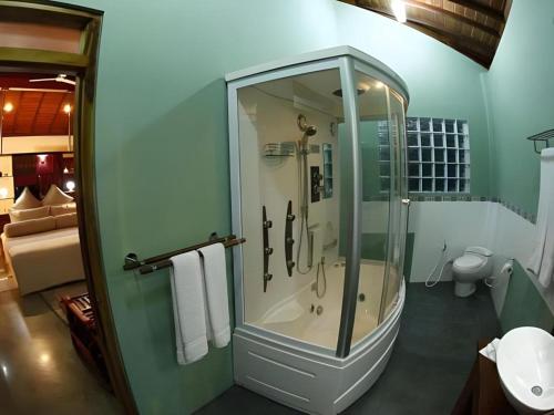 a bathroom with a shower with a glass door at Brook Boutique in Madahapola