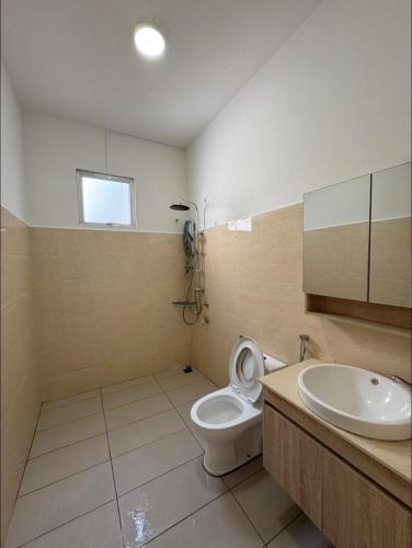 a bathroom with a toilet and a sink at SDC Suite Home 6 in Lahad Datu