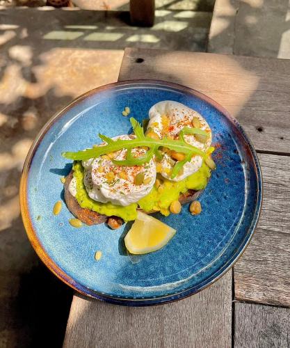 a blue plate with food on a wooden table at Paraiso Hotel Chiangmai in Chiang Mai