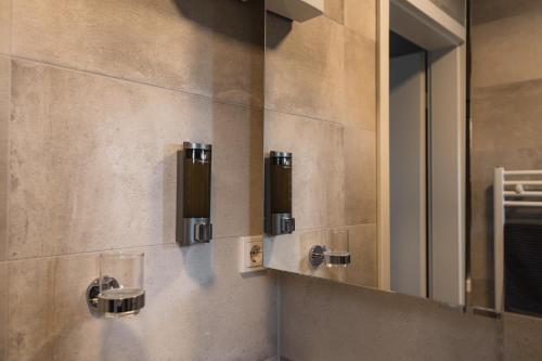 a bathroom with a sink and a mirror at NürbLife Hotel in Nürburg