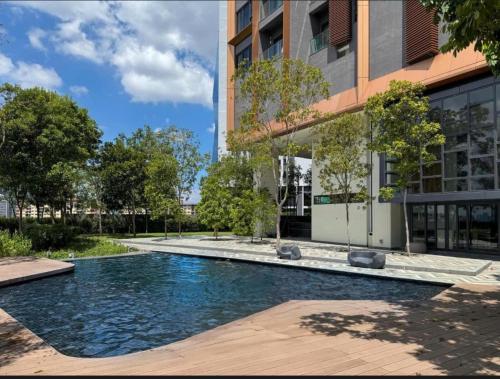 a swimming pool in front of a building at Smart Home at Lucentia Residence BBCC Lalaport in Kuala Lumpur