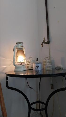 a table with a lantern sitting on top of it at Orfeas Villa in Kotróni
