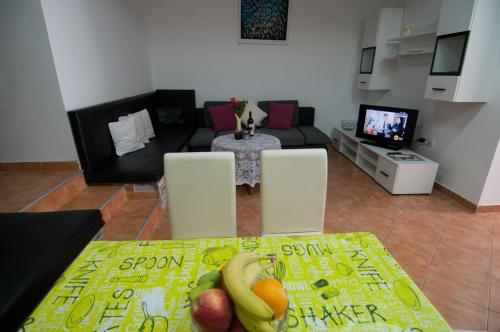 a living room with a table with fruit on it at Apartment Tomic A-5 in Lovran