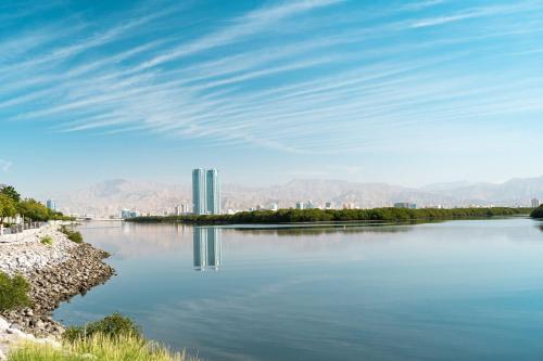 a view of a river with a city in the background at Stunning Corniche view in Ras al Khaimah