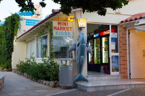 a store with a shark statue in front of it at Rethymno Mare & Water Park in Rethymno Town