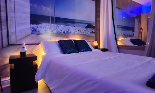 a bedroom with a white bed and a view of the ocean at Ocean Spa Oasis in Port Saint Lucie