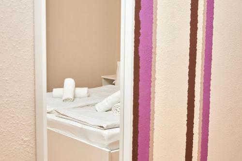 a small room with a bed with towels on it at Tompos Vendégház és pince in Villány