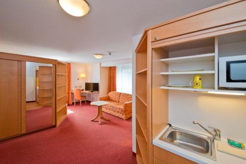 a hotel room with a bathroom and a living room at Hotel Bären in Rottweil