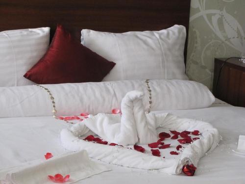 a bed with a swan made out of roses at Hotel Hubert Nové Zámky in Nové Zámky