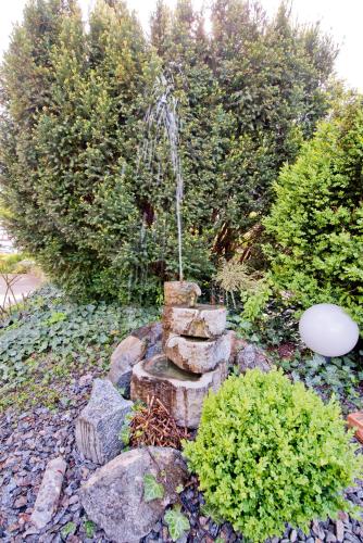 a fountain in the middle of a garden at Hotel Bären in Rottweil